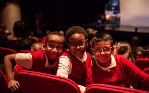 Three children in the audience at Children's Theatre Company