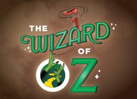 Stylized "The Wizard of Oz" text with red shoes above and inside the letter "O" green hands reaching up with a yellow brick road. Brown background.