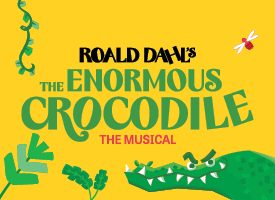 Illustrated green crocodile with open mouth next to the text "Roald Dahl's The Enormous Crocodile The Musical" on a yellow background.