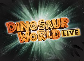 The text "DINOSAUR WORLD LIVE" appears in bold, textured orange and yellow lettering in a white spotlight against a dark background with scattered black and white dinosaur footprints.